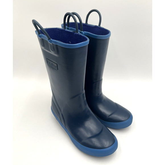 Black Dunlop Dee Wellies in a puddle. | Here is a POV photo